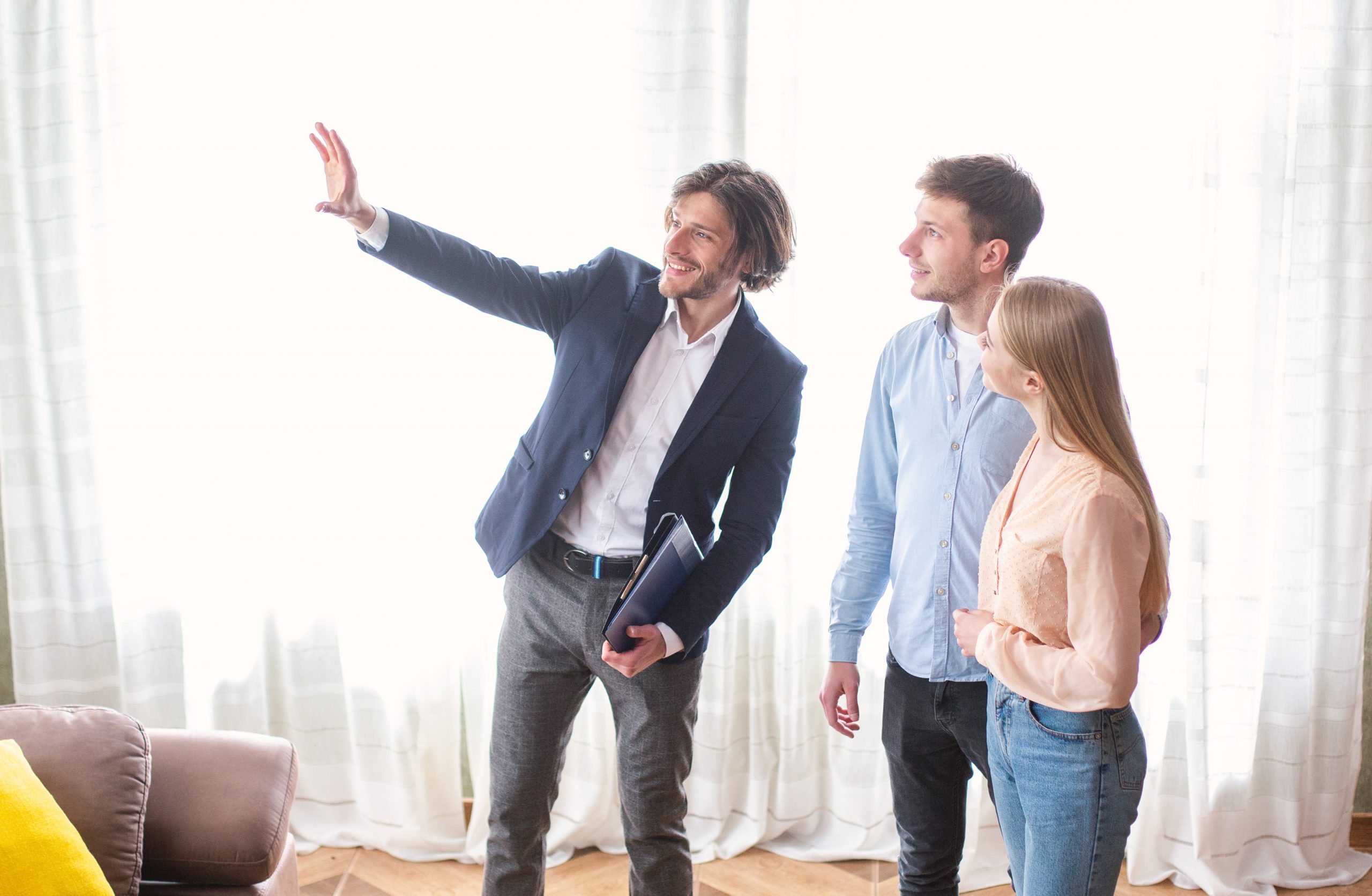 Couple with cheerful sales person